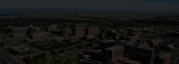 University of Colorado Anschutz Medical Campus with front range mountains in the background in Denver, Colorado, with a dark overlay across the whole image